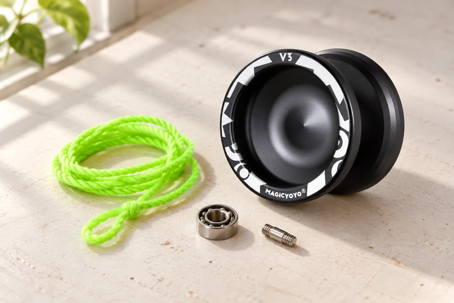 Black MAGICYOYO V3 on a practice table with string, bearing and axle